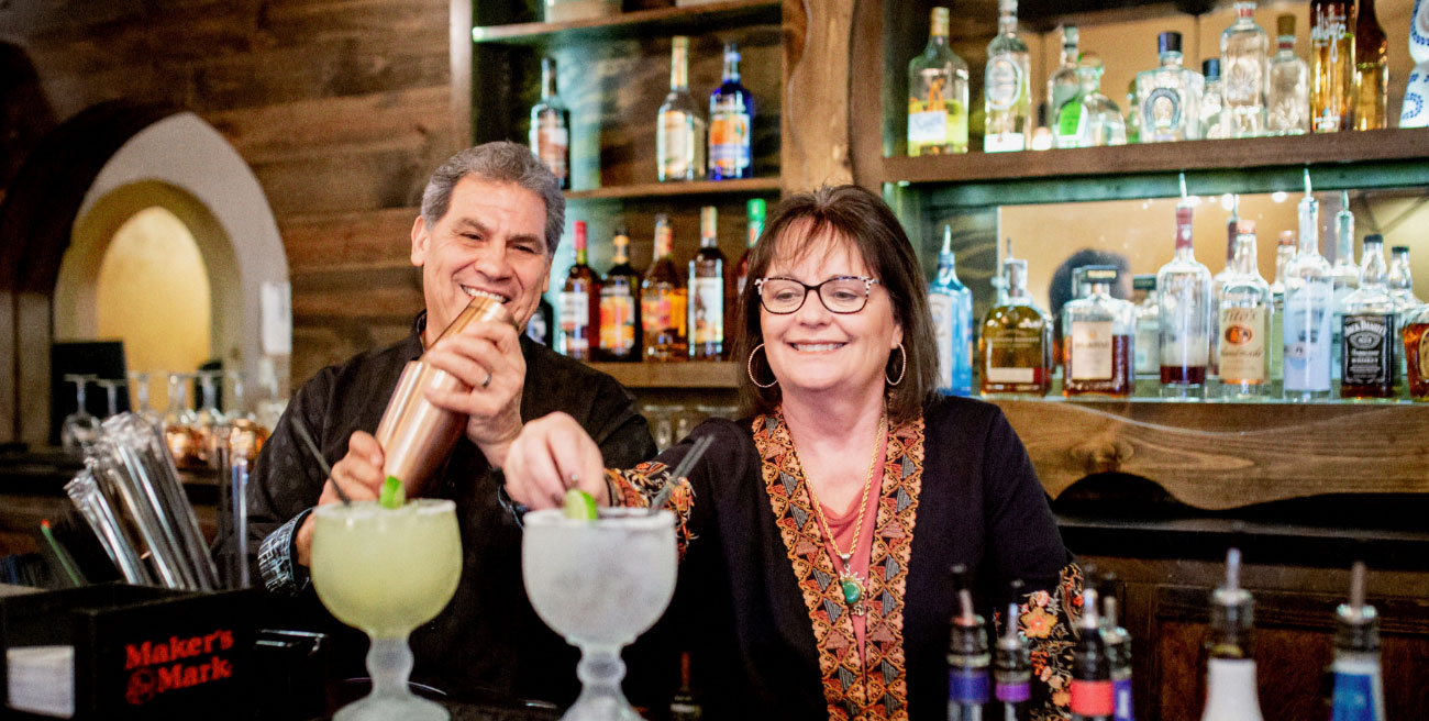 couple mixing margharitas